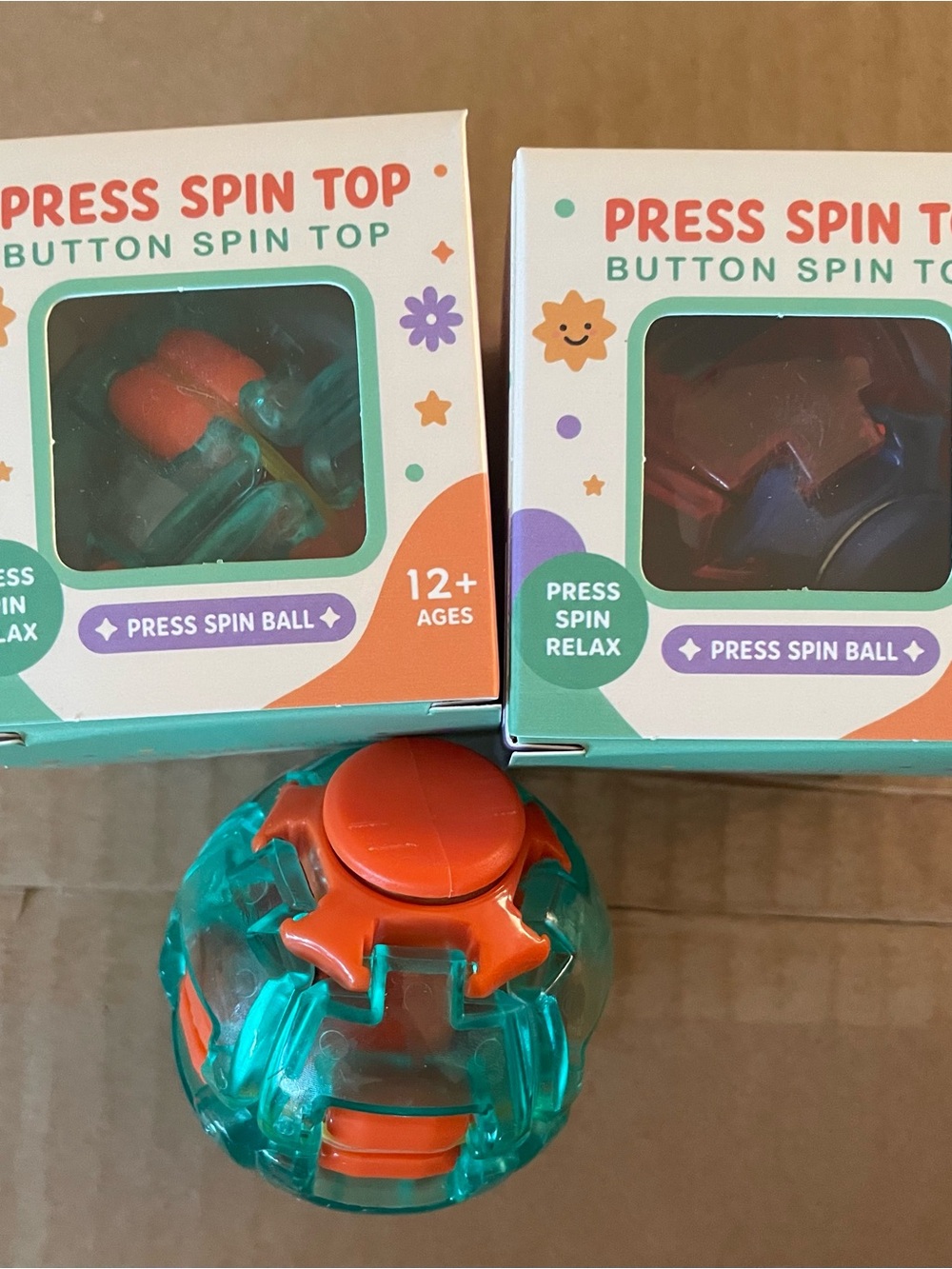 Press Spin Top Button Spin Toy - Orange & Teal